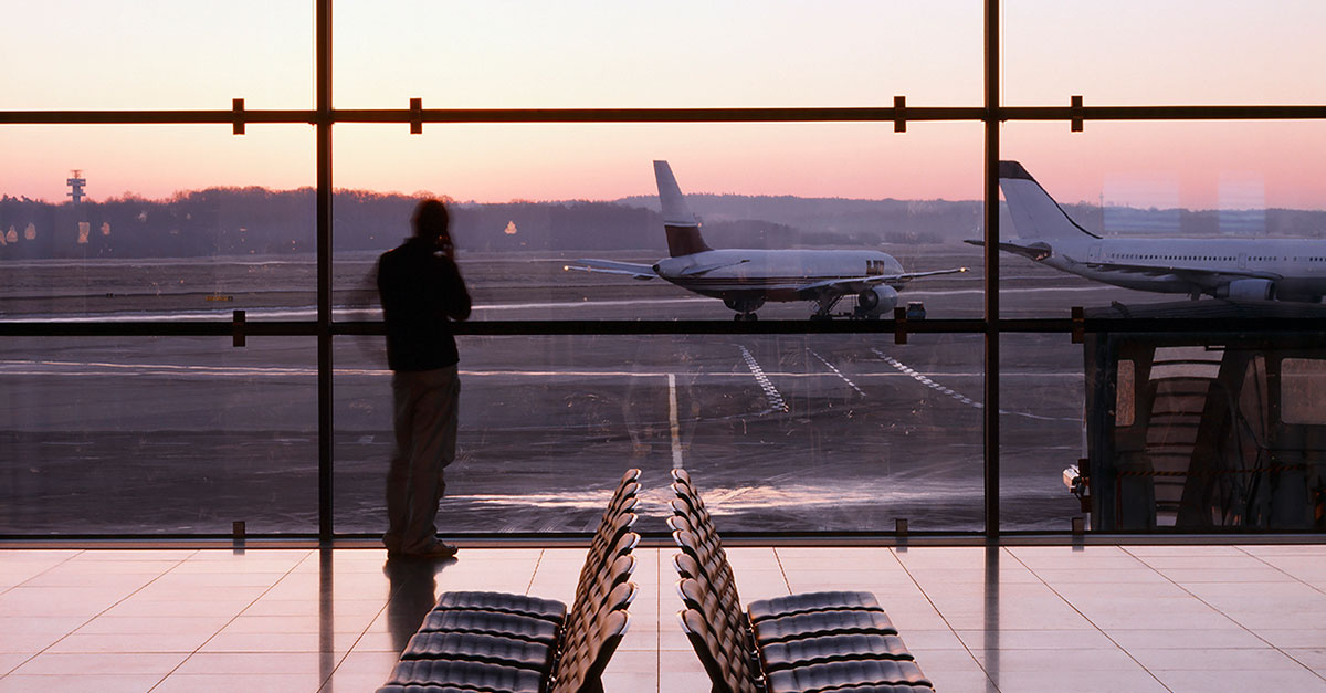 silhouetto of a man in an airport at dusk