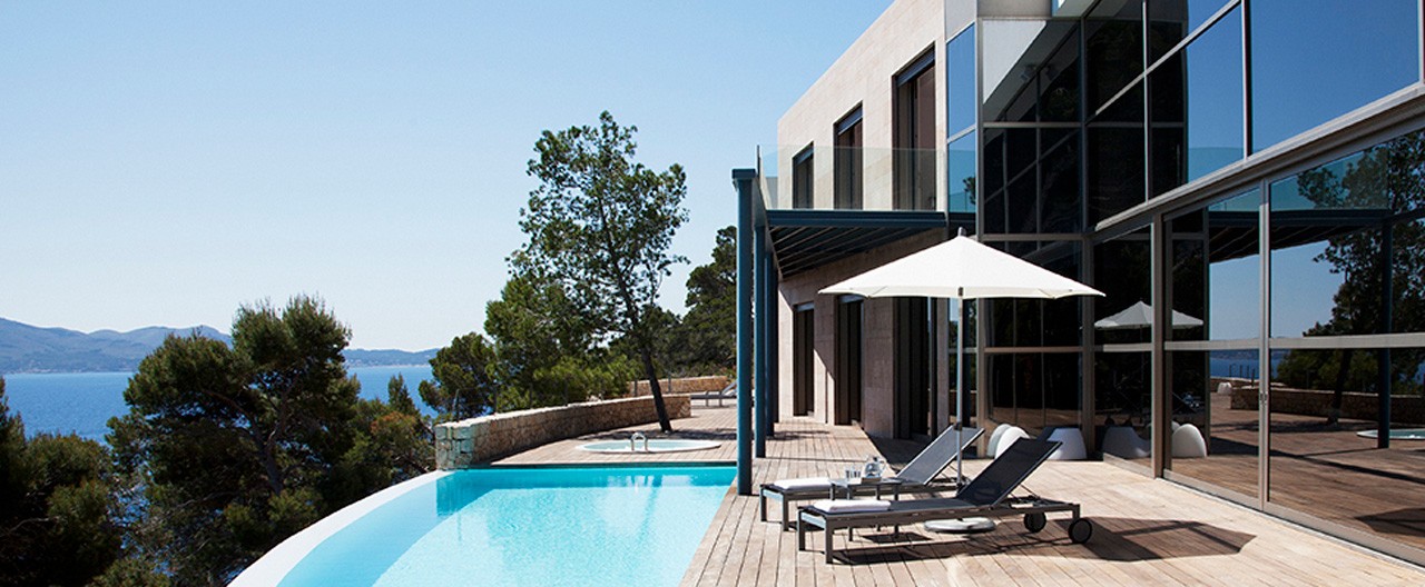 house with a pool and ocean view