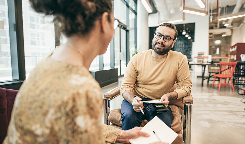 two businesspeople discuss strategy