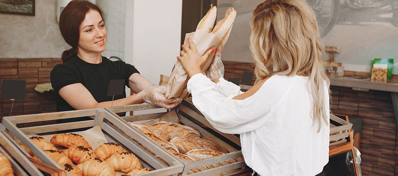 girl buys bread at the bakery