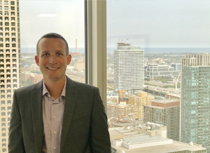 a man in a suit standing in front of a window