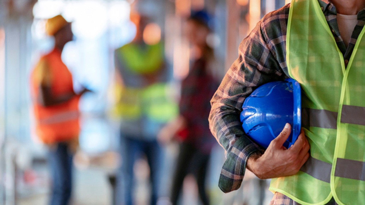 man holding blue helmet