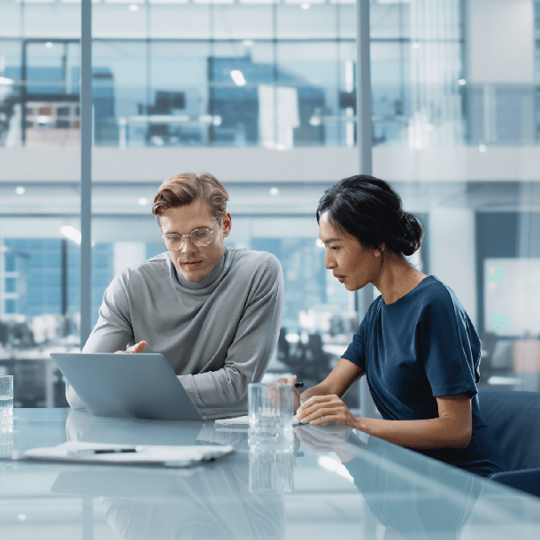 colleagues discussing over laptop