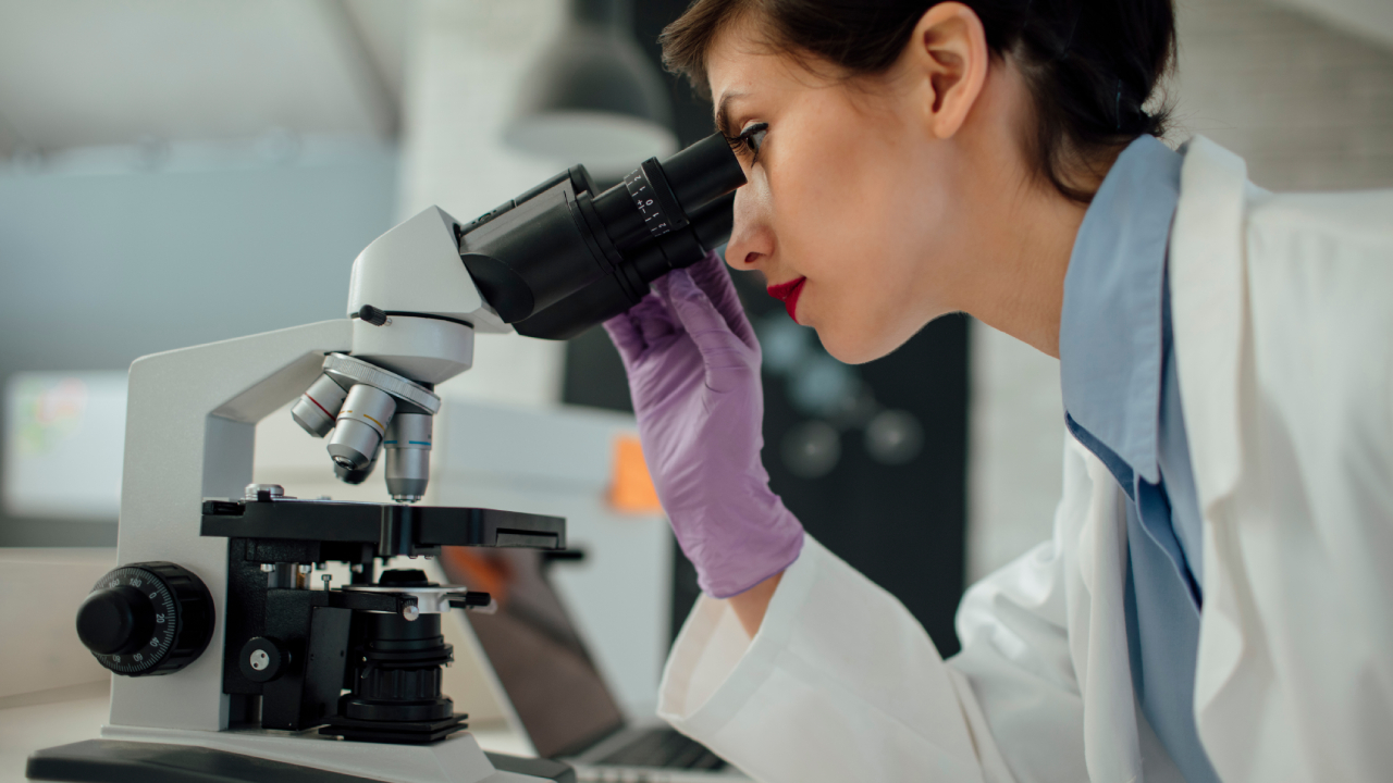 researcher using microscope