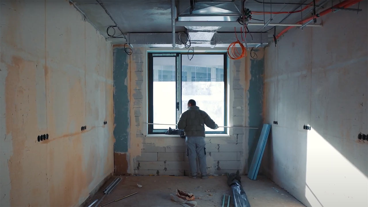 man looking out from window