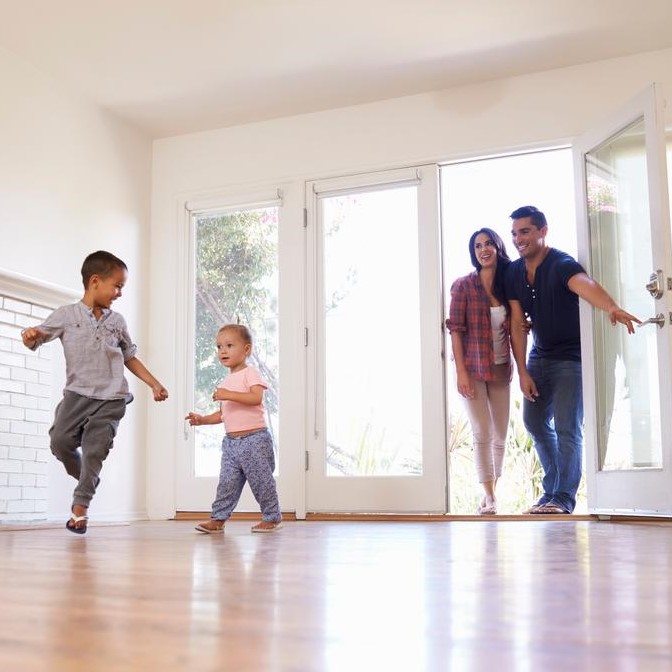 family entering their new home