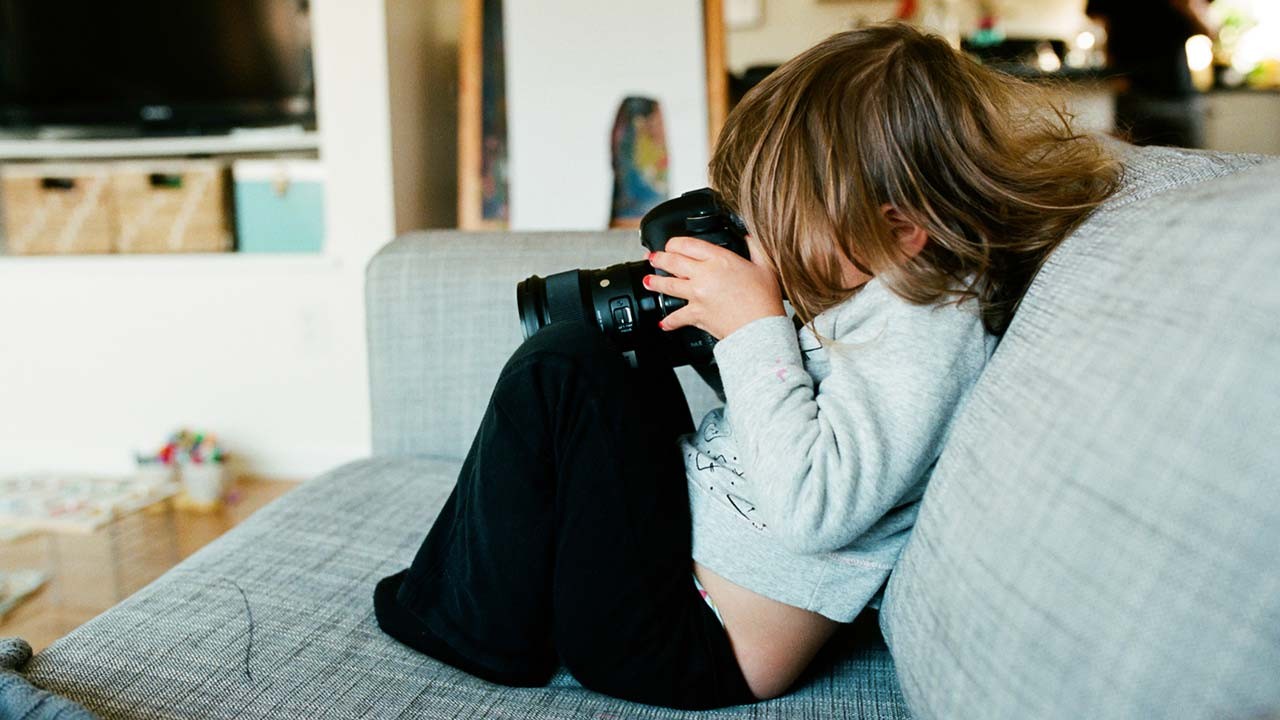 little girl with big camera