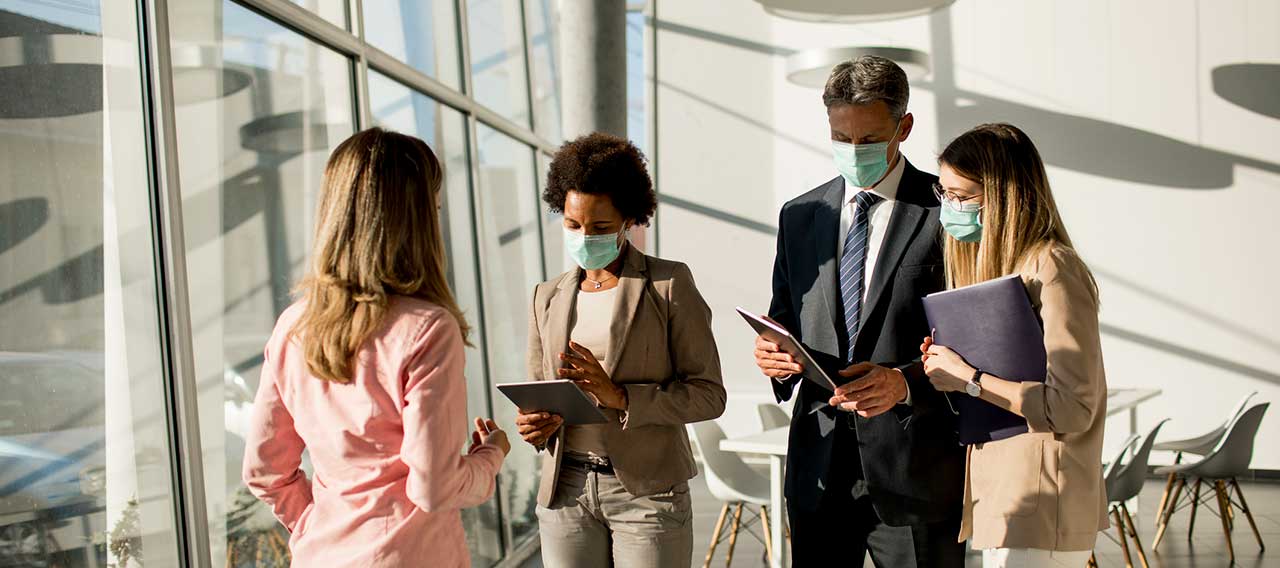 business people wearing masks in meeting
