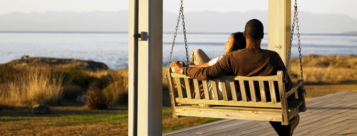 two people sitting on a swing