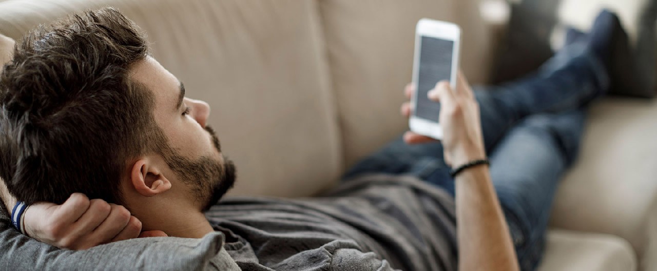 a guy lays on the couch