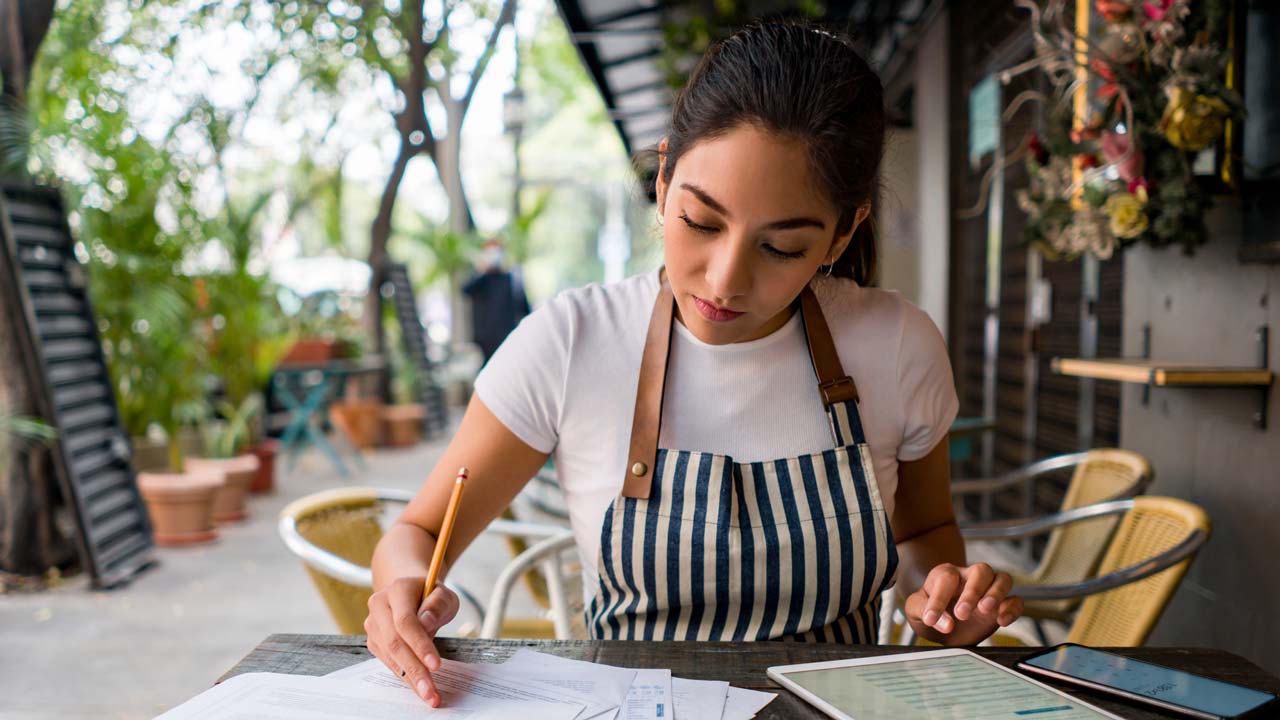 small business cafe owner reviewing small business insurance policies
