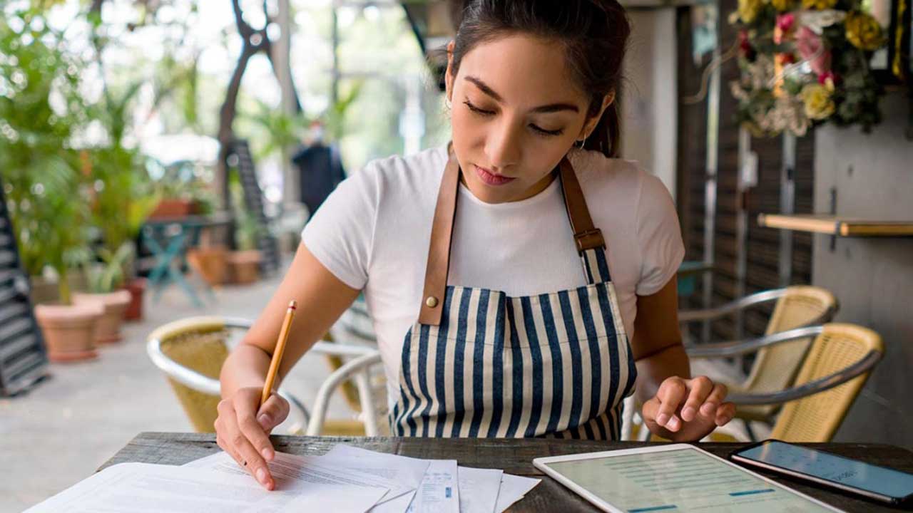 small business cafe owner reviewing small business insurance policies