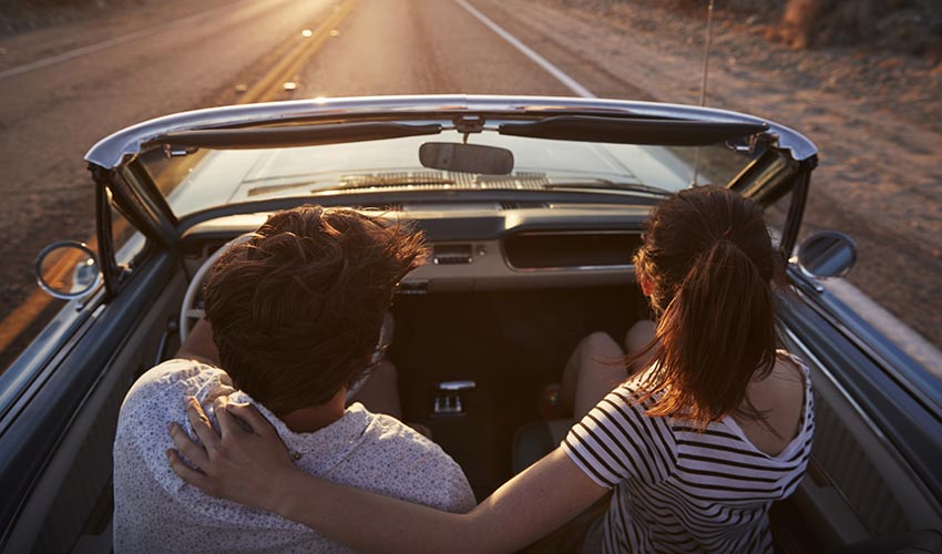 couple riding in classic car