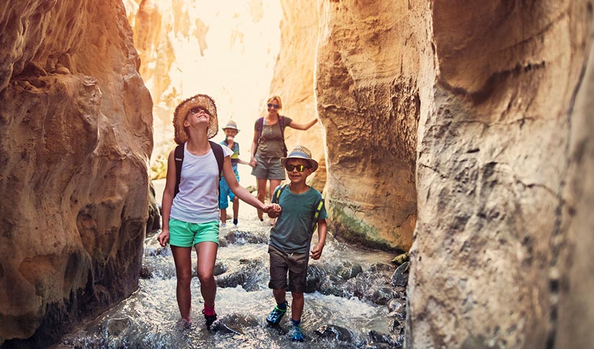 family hiking through canyon