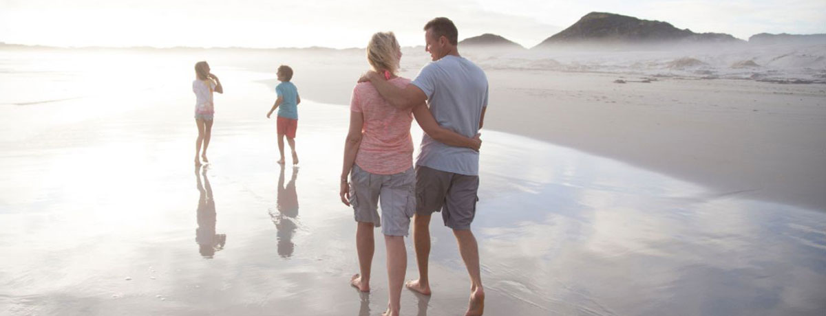 Family walking on beach
