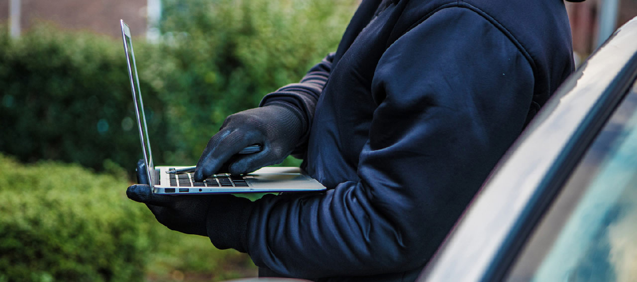 hacker beside car