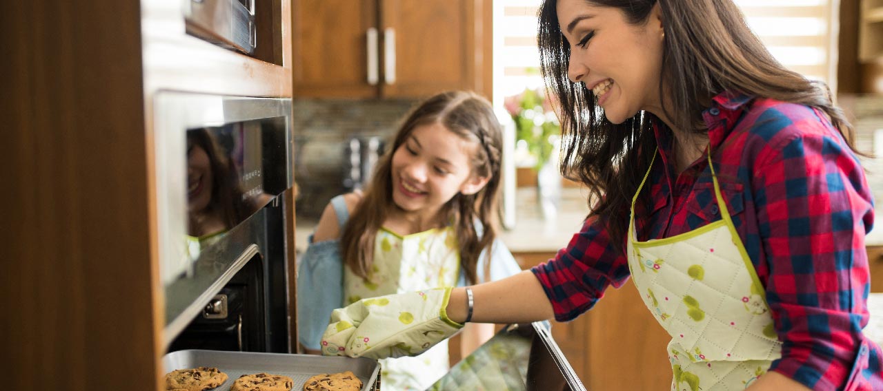 mom and daughter baking together