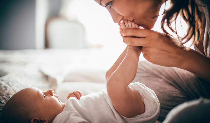 mom kisses baby's feet