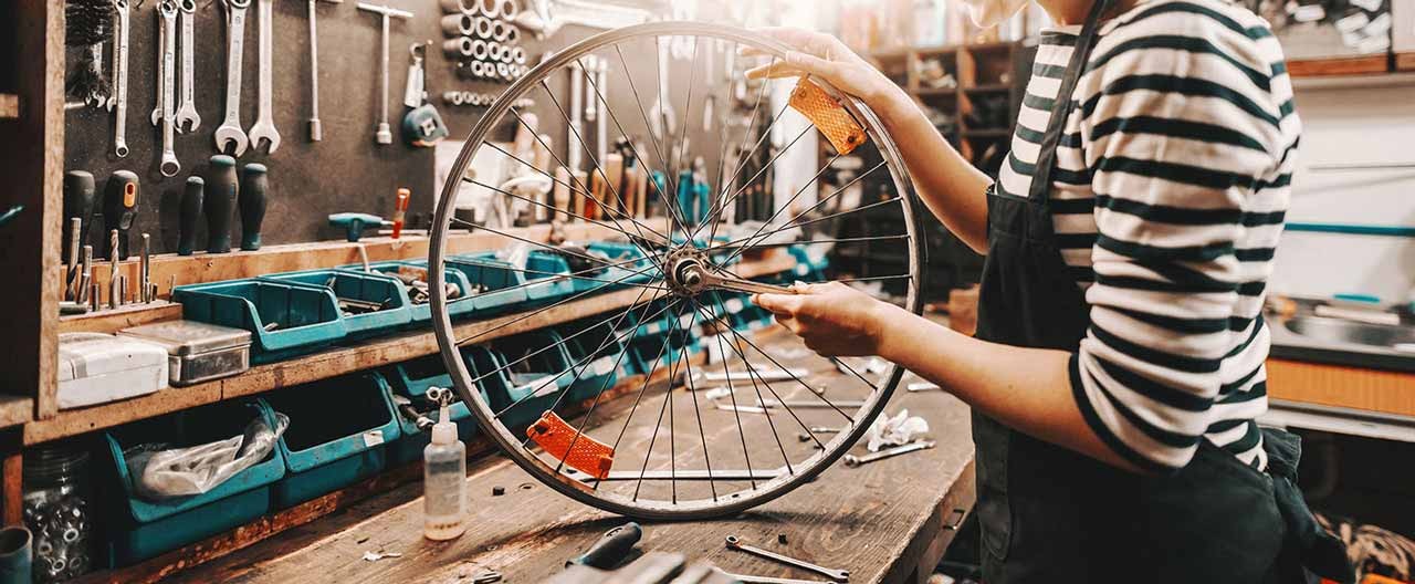woman doing bike shop repair