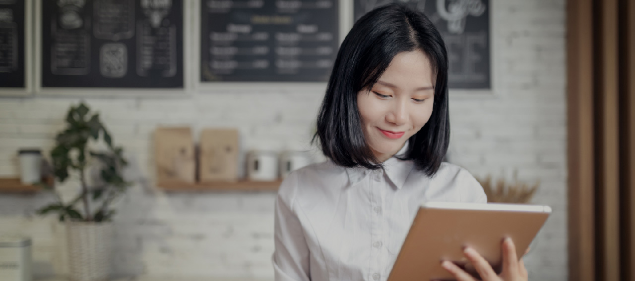 woman holding a book in cafe