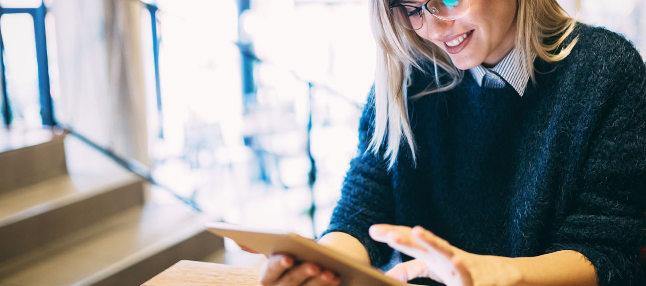 Portrait of young attractive woman using tablet