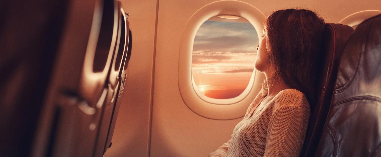 woman looking at the airplane window