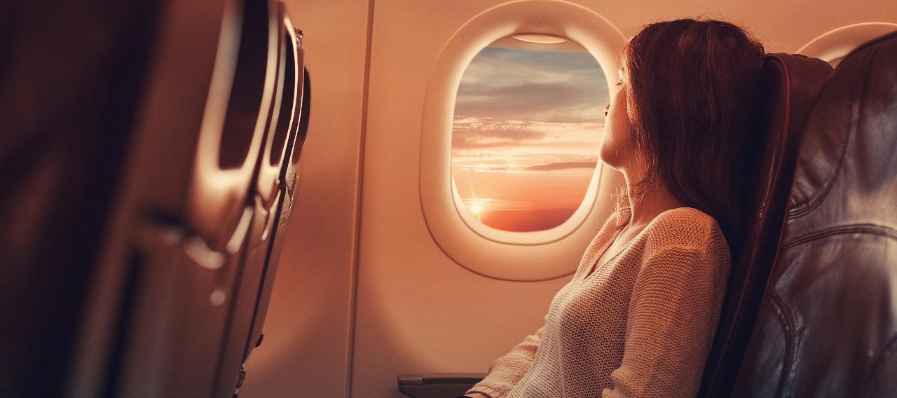 woman looking at the airplane window