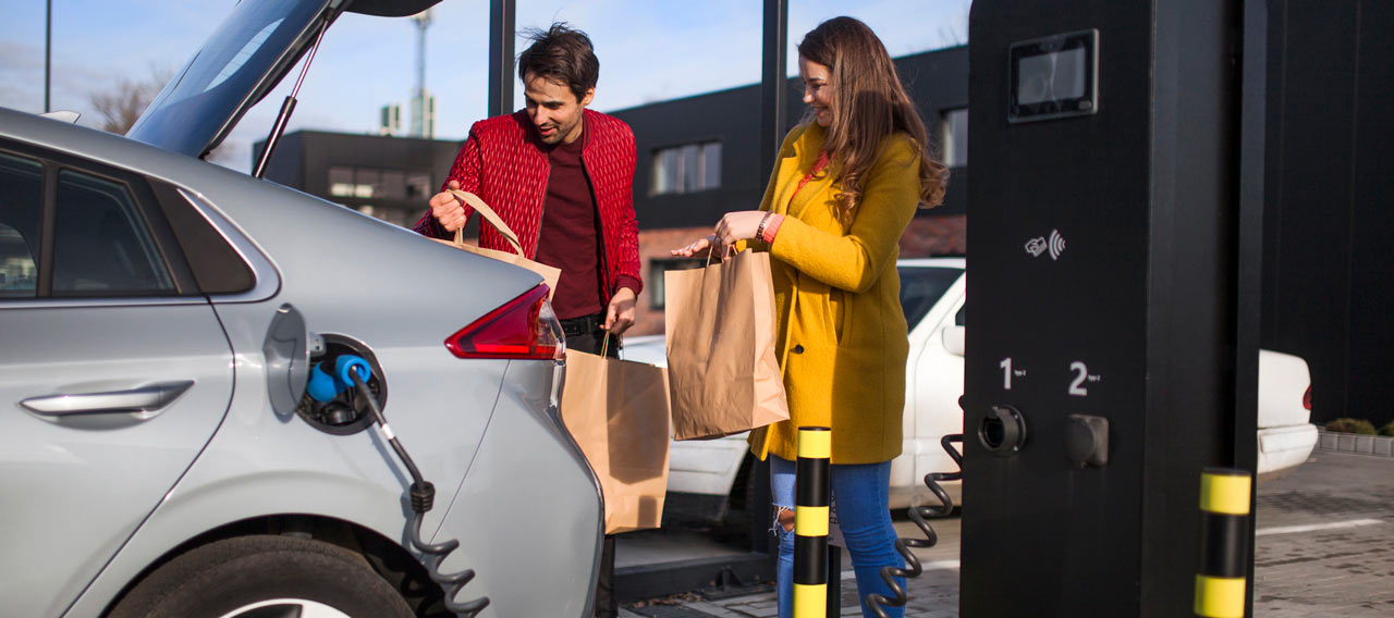 young couple charging EV