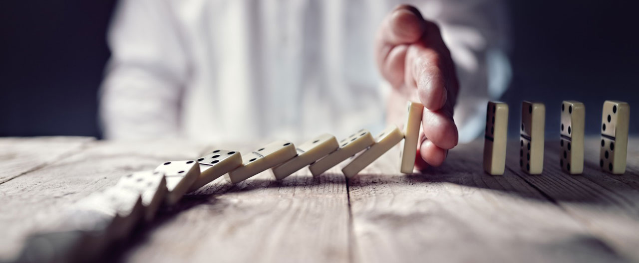man plays with dominos