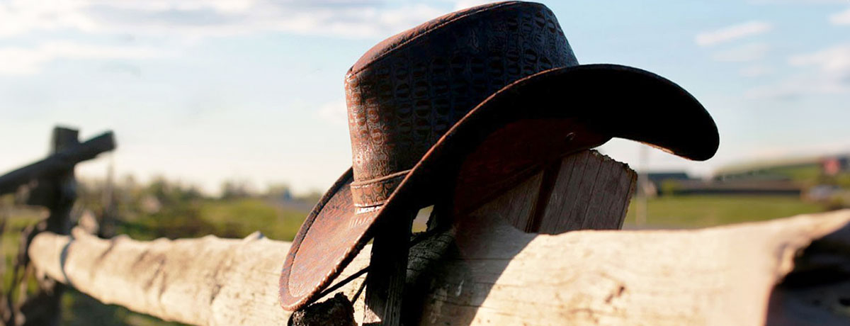 cowboy hat on a fence