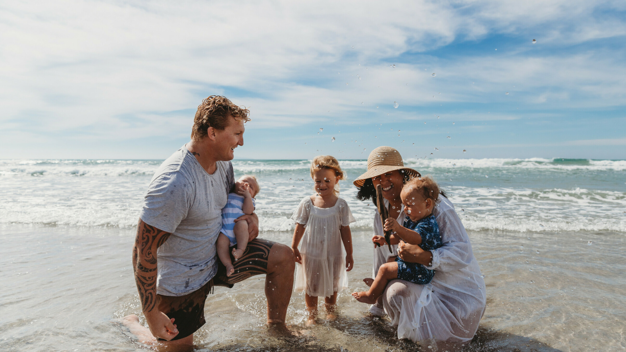 family laughing at beach